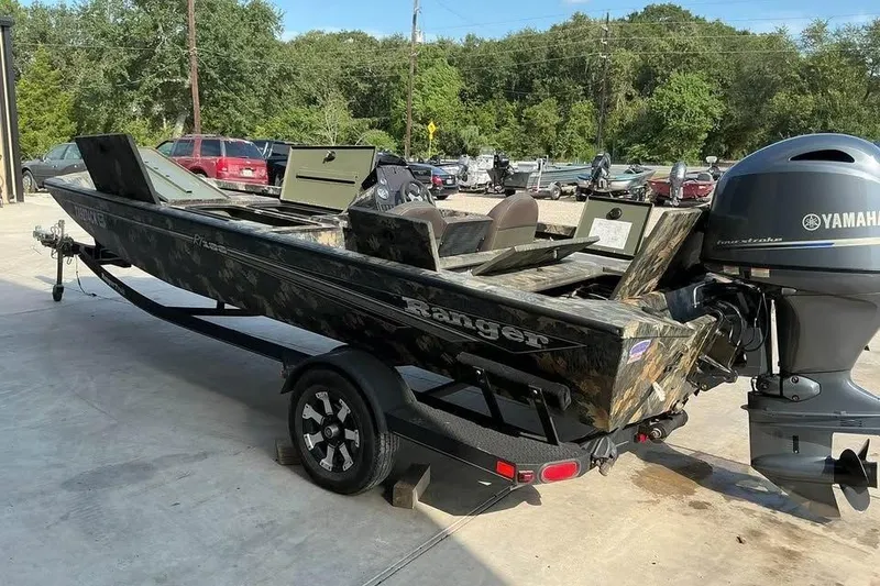 Slide: The Image of 2015 Ranger RT188 boat with Yamaha motor on trailer, parked outdoors. - 1