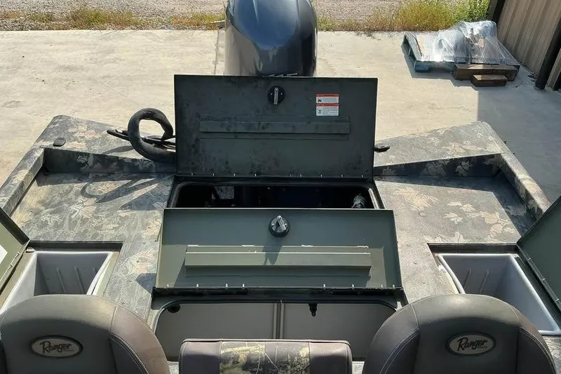 Slide: The Image of 2015 Ranger RT188 boat interior with open storage compartments and motor view. - 4