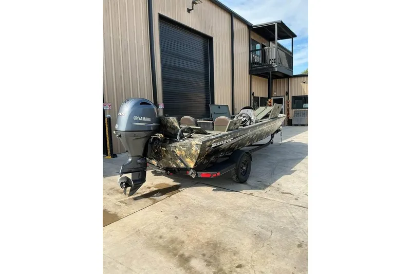 Slide: The Image of 2015 Ranger RT188 boat with Yamaha motor parked outside a building. - 7