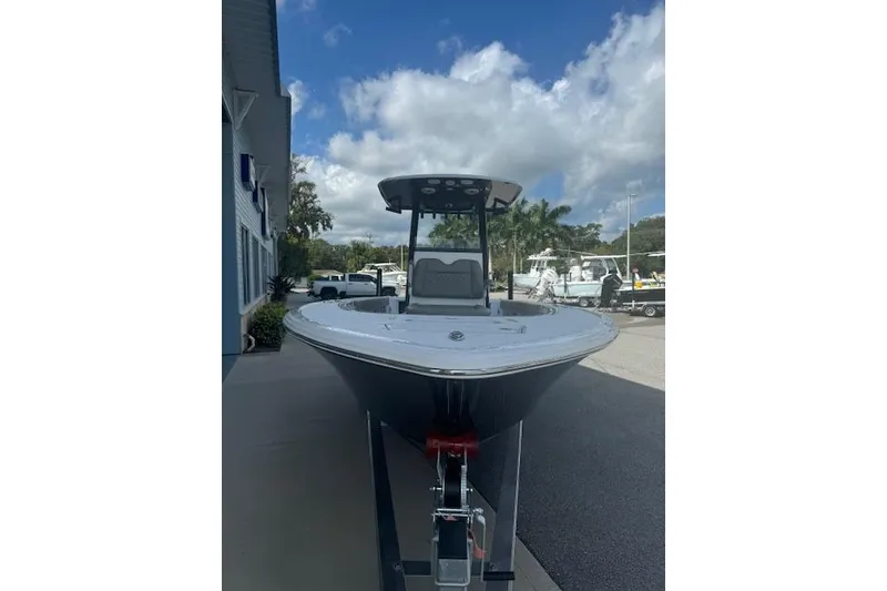 Slide: The Image of 2025 Sportsman Masters 267OE Bay Boat on trailer under blue sky. - 20