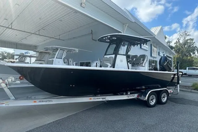 Slide: The Image of 2025 Sportsman Masters 267OE Bay Boat on trailer, parked outside a building. - 22