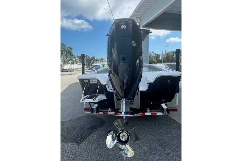 Slide: The Image of 2025 Sportsman Masters 267OE Bay Boat on trailer, sleek black design, parked outdoors. - 4