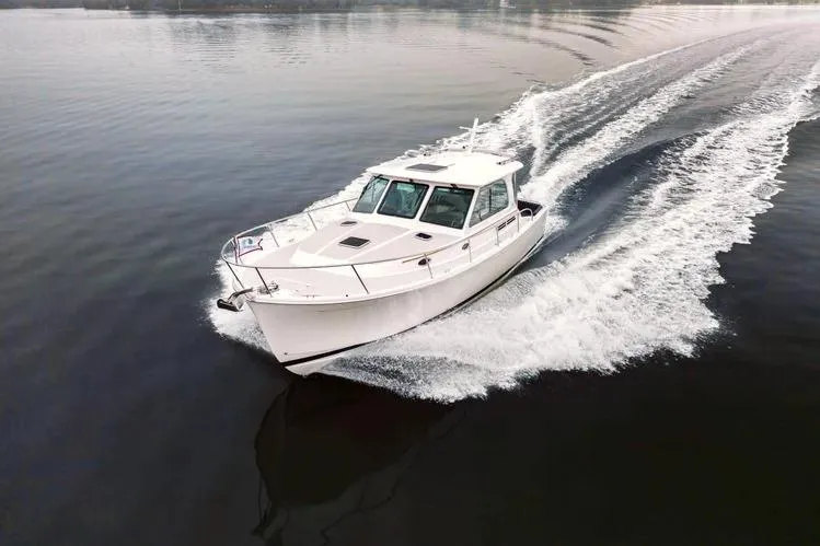 The Image of 2014 Back Cove 37 Downeast cruising on calm waters, showcasing sleek design and performance. - 1