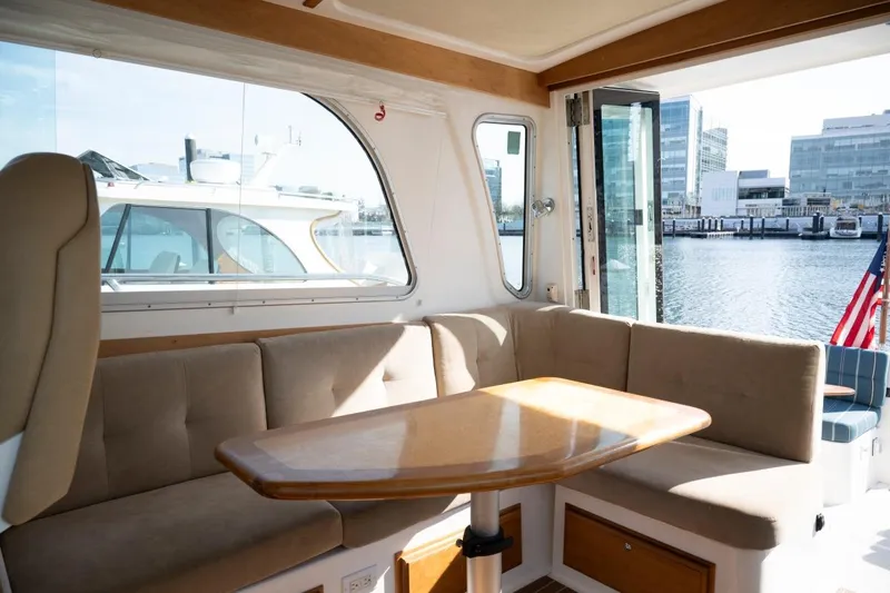 Slide: The Image of Interior of 2014 Back Cove 37 yacht with seating and table, overlooking marina. - 16