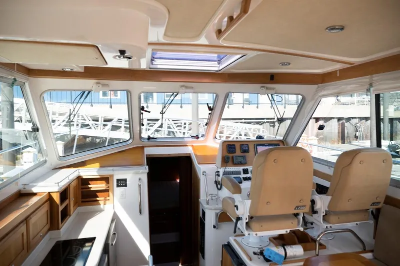 Slide: The Image of Interior of 2014 Back Cove 37 yacht with helm, seating, and navigation equipment. - 18