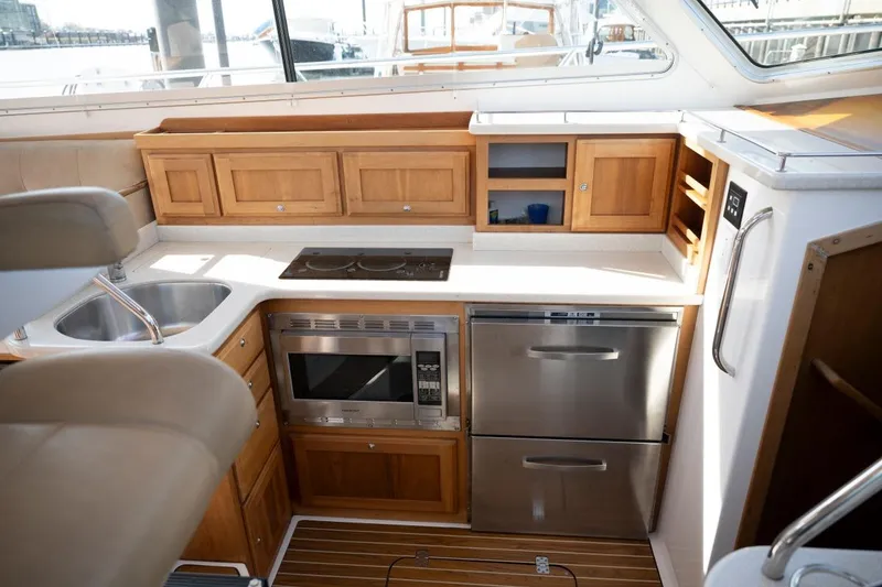 Slide: The Image of Luxurious 2014 Back Cove 37 yacht kitchen with modern appliances and wooden cabinetry. - 20