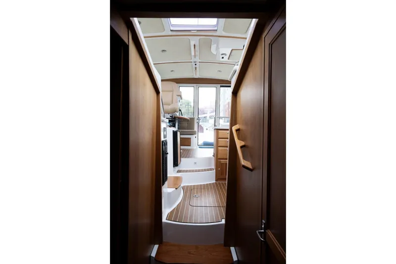 Slide: The Image of Interior view of 2014 Back Cove 37 yacht, featuring wooden finishes and modern design. - 37