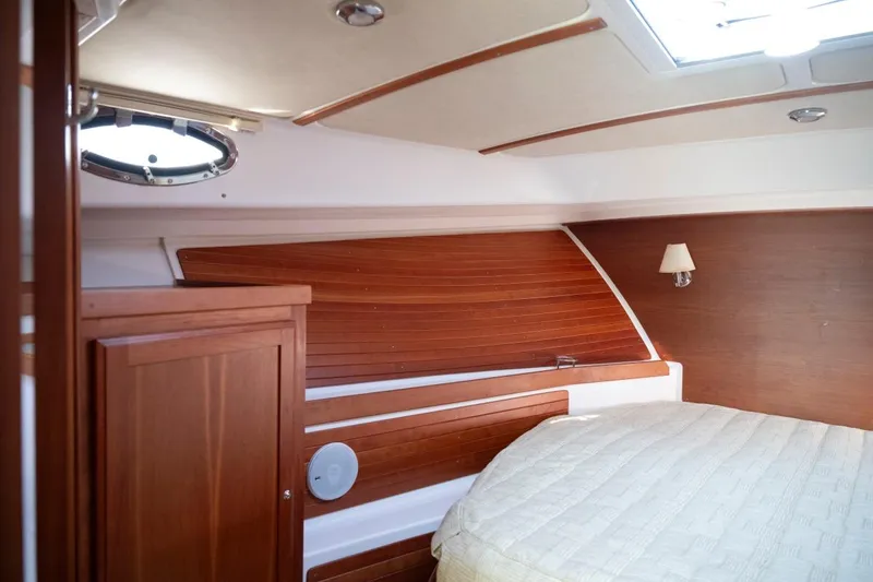 Slide: The Image of Luxurious cabin interior of 2014 Back Cove 37 yacht with wood paneling and cozy bed. - 38