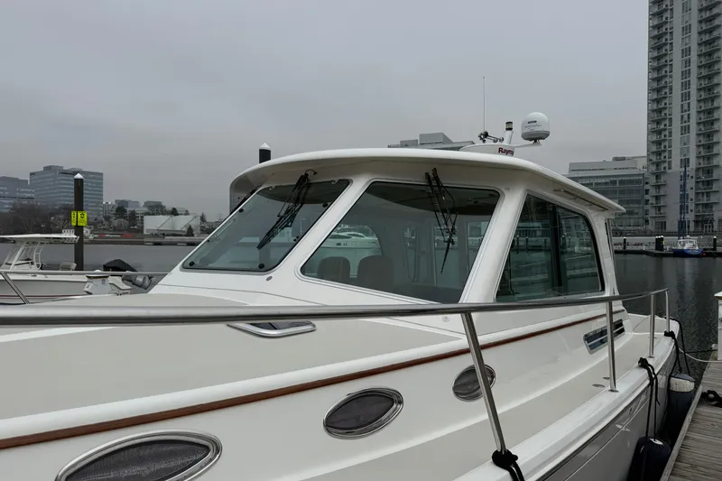 Slide: The Image of 2014 Back Cove 37 boat docked in urban marina setting. - 4