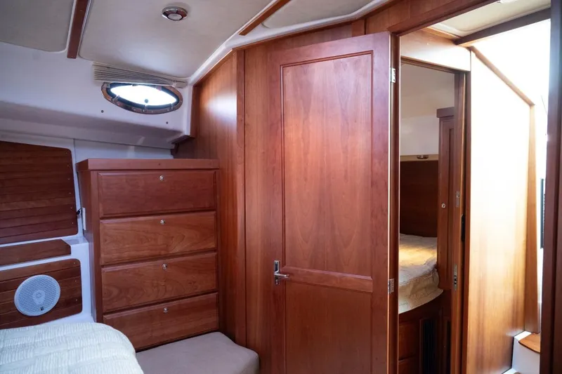 Slide: The Image of 2014 Back Cove 37 yacht interior with wooden cabinetry and cozy bedroom. - 40