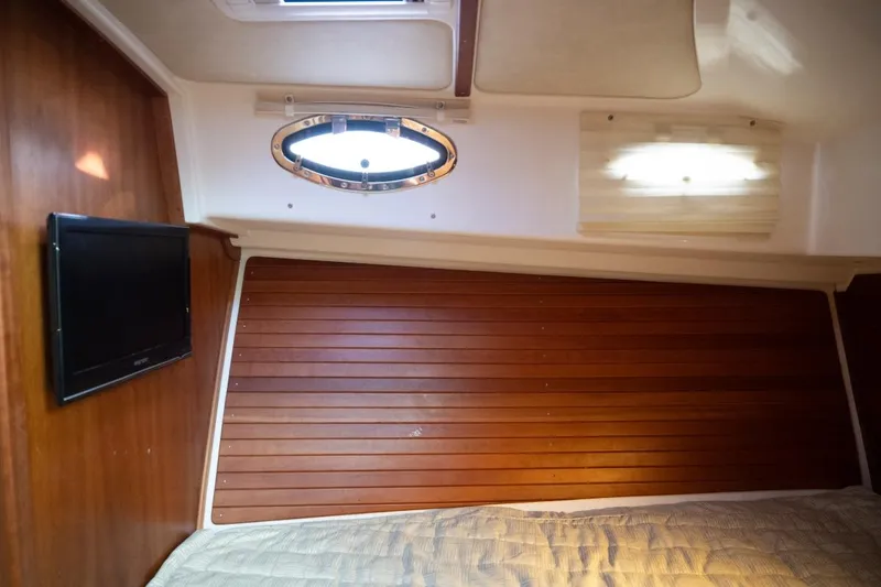 Slide: The Image of Cozy cabin interior of 2014 Back Cove 37 yacht with wood paneling and porthole window. - 41
