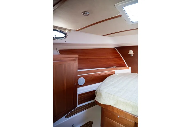 Slide: The Image of Luxurious cabin interior of 2014 Back Cove 37 yacht with wood paneling and cozy bed. - 42