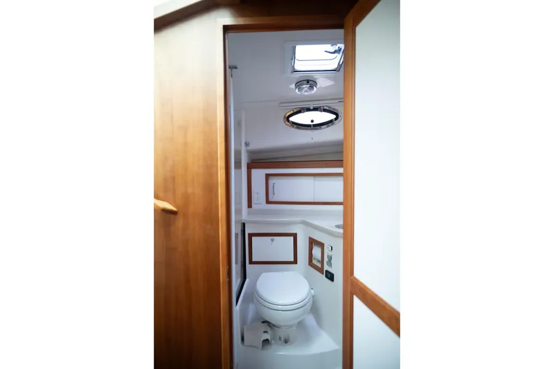 Slide: The Image of 2014 Back Cove 37 yacht bathroom with wooden accents and overhead skylight. - 43