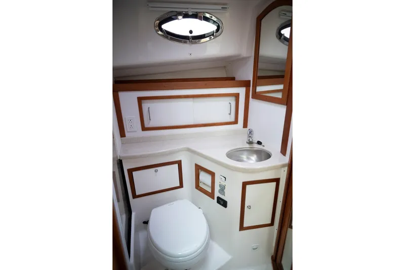 Slide: The Image of 2014 Back Cove 37 yacht bathroom with sink, toilet, and storage cabinets. - 44