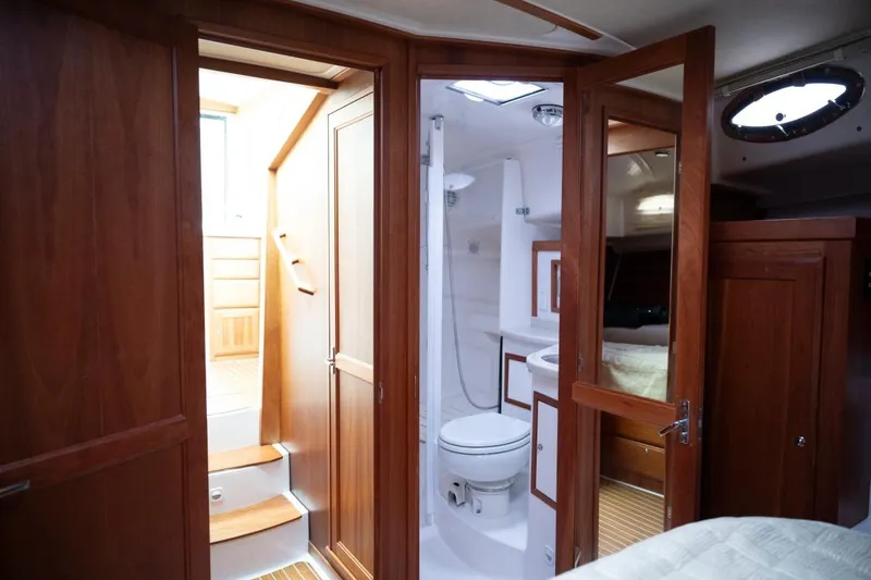 Slide: The Image of Interior of 2014 Back Cove 37 yacht featuring wooden cabinetry and compact bathroom. - 48