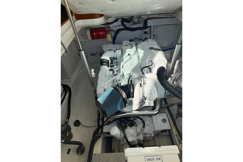 Slide: The Image of Engine compartment of a 2014 Back Cove 37 boat, featuring a clean, organized layout. - 49