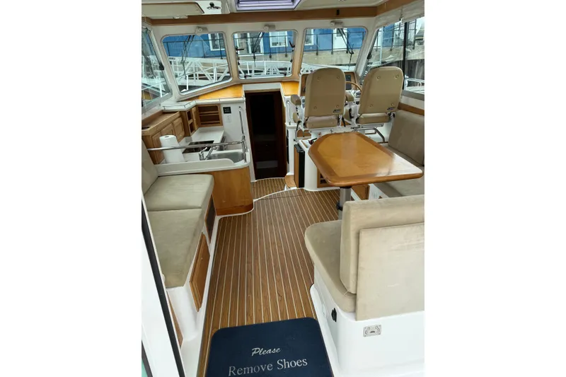 Slide: The Image of Interior of a 2014 Back Cove 37 boat with seating and helm station. - 9