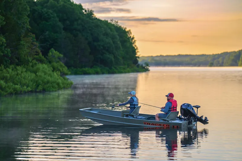 Slide: The Image of Manufacturer Provided Image: Two people fishing on a 2025 Tracker Grizzly 14 Jon boat at sunset. - 38
