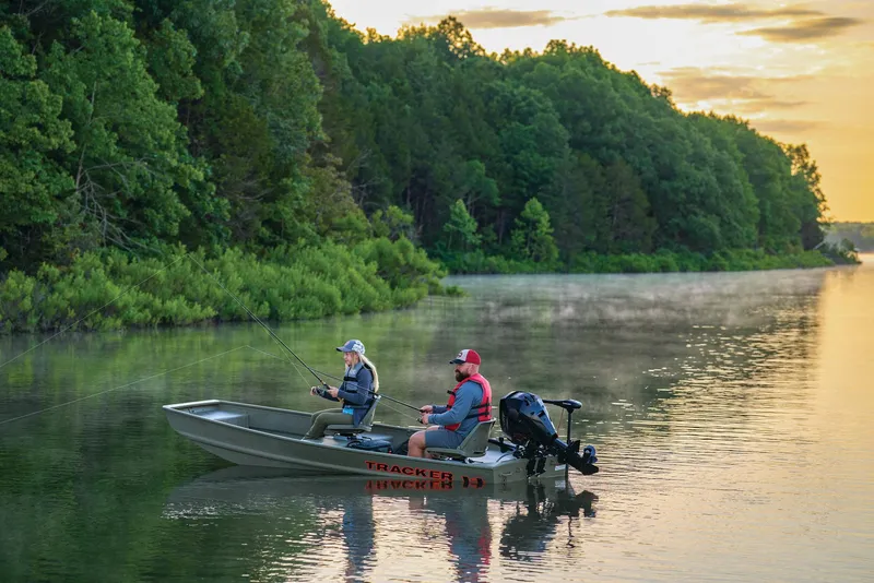Slide: The Image of Manufacturer Provided Image: Two people fishing on a 2025 Tracker Grizzly 14 Jon boat in a serene lake. - 39
