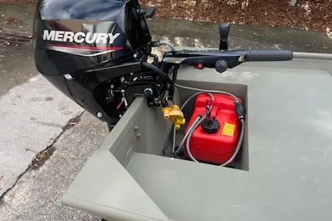 Slide: The Image of 2025 Tracker Grizzly 14 Jon boat with Mercury outboard motor and red fuel tank. - 4