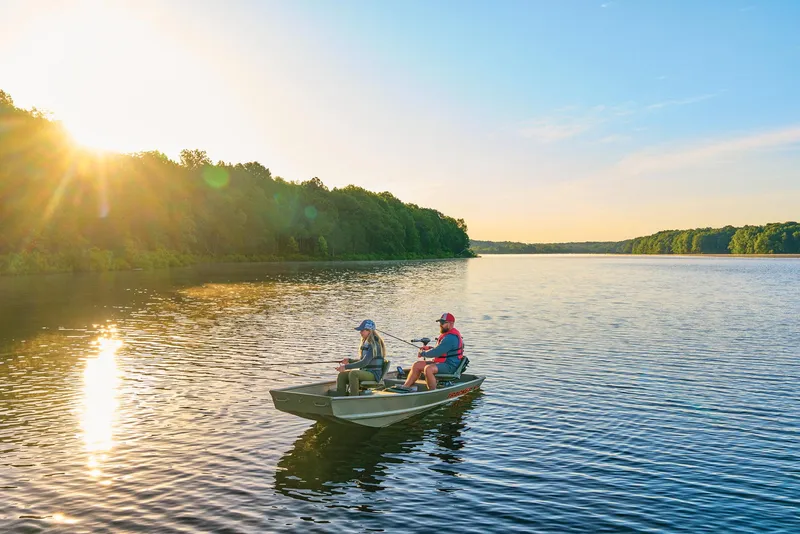 Slide: The Image of Manufacturer Provided Image: Two people fishing on a 2025 Tracker Grizzly 14 Jon boat at sunset. - 41