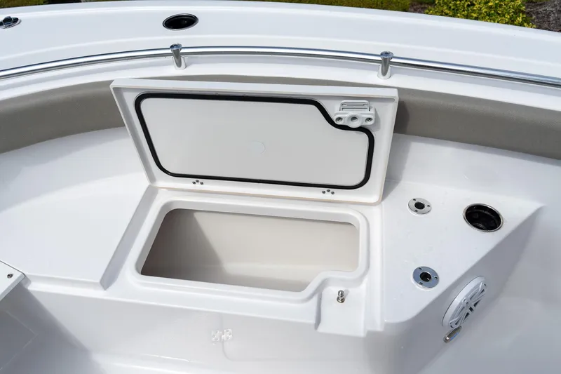Slide: The Image of 2025 Sportsman Open 212 Center Console boat storage compartment with open lid. - 10
