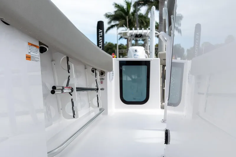 Slide: The Image of 2025 Sportsman Open 212 Center Console boat interior with rod holders and seating. - 12