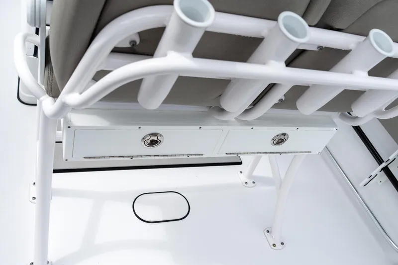 Slide: The Image of 2025 Sportsman Open 212 Center Console boat seat with rod holders and storage. - 15