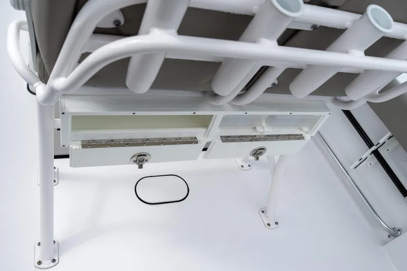 Slide: The Image of 2025 Sportsman Open 212 Center Console storage compartments and rod holders. - 16