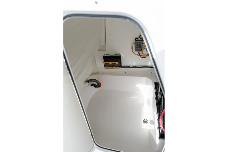 Slide: The Image of 2025 Sportsman Open 212 Center Console interior wiring and storage compartment. - 24