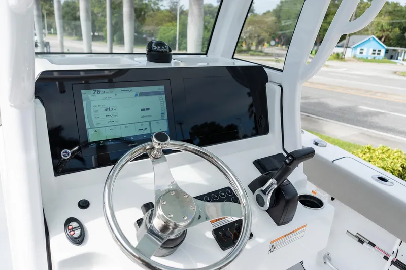 Slide: The Image of 2025 Sportsman Open 212 Center Console dashboard with steering wheel and digital display. - 25