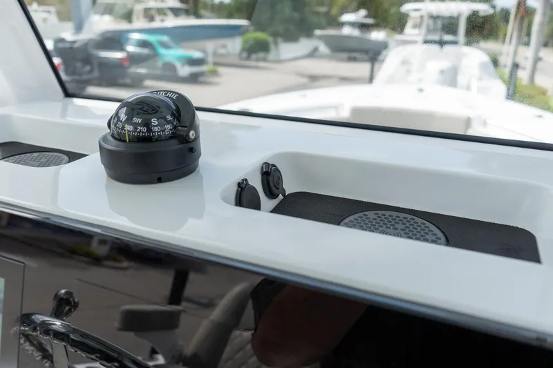 Slide: The Image of 2025 Sportsman Open 212 Center Console dashboard with compass and speaker. - 26