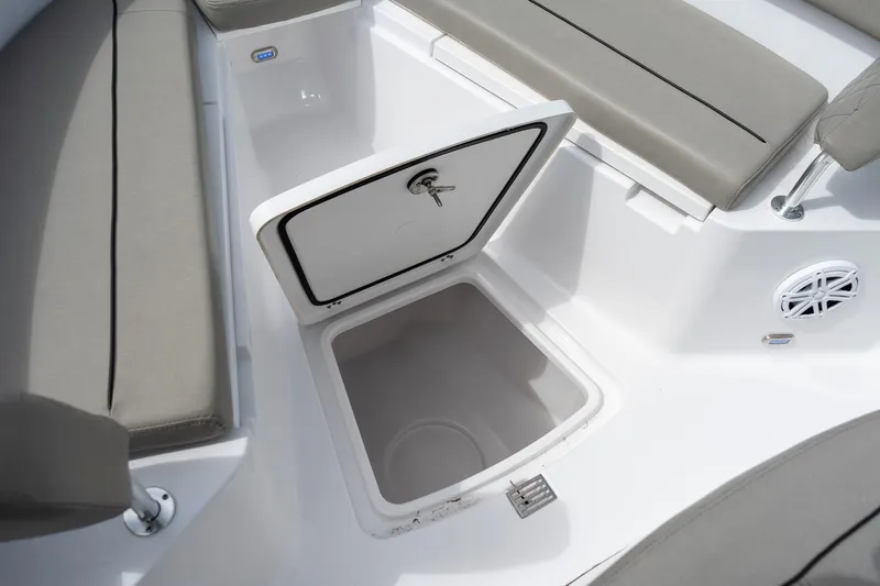 Slide: The Image of 2025 Sportsman Open 212 Center Console boat with open storage compartment and cushioned seating. - 39