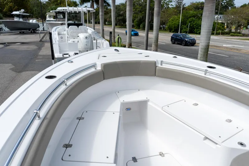 Slide: The Image of 2025 Sportsman Open 212 Center Console boat, spacious deck view, parked near palm trees. - 44
