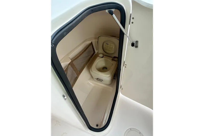 Slide: The Image of 2006 Grady-White Tournament 225 boat toilet compartment with open door. - 4