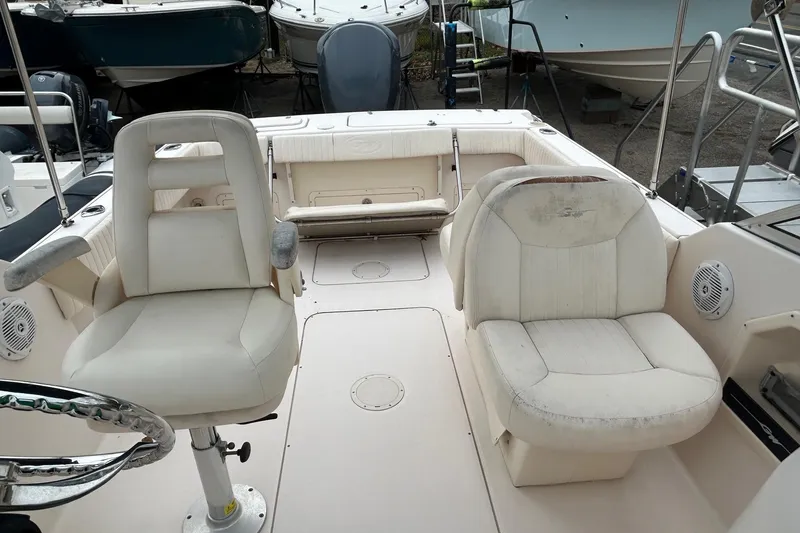 Slide: The Image of 2006 Grady-White Tournament 225 boat interior with white seating and steering wheel. - 6