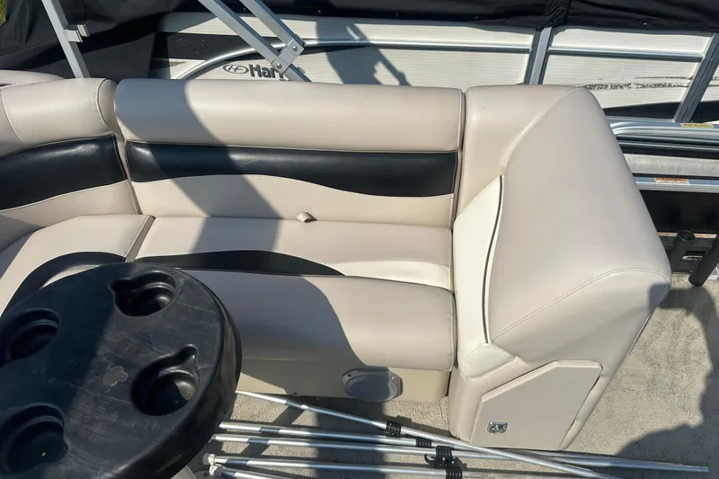 Slide: The Image of 2013 Sweetwater 2086 RE boat interior with beige and black seating. - 13