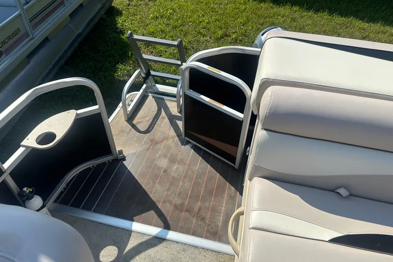 Slide: The Image of 2013 Sweetwater 2086 RE pontoon boat interior with seating and open gate. - 15