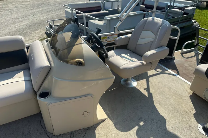 Slide: The Image of 2013 Sweetwater 2086 RE boat interior with steering console and captain's chair. - 6