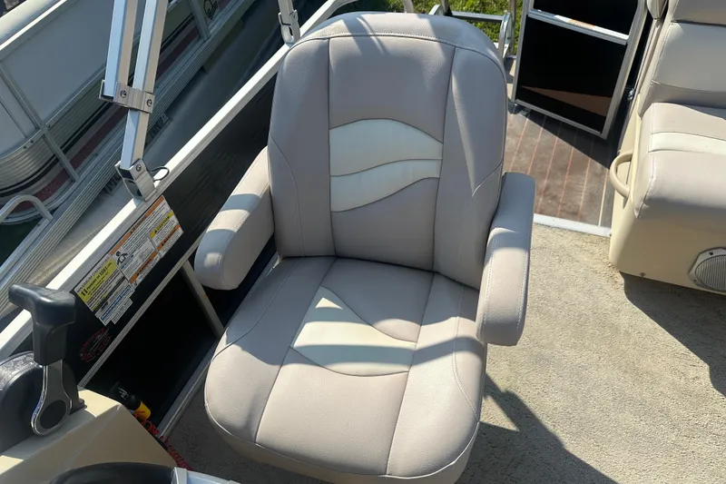 Slide: The Image of Captain's chair on 2013 Sweetwater 2086 RE pontoon boat, featuring beige upholstery. - 7