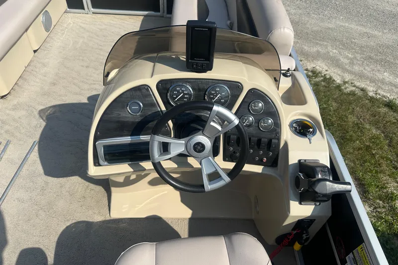 Slide: The Image of Steering console of a 2013 Sweetwater 2086 RE boat with gauges and controls. - 8