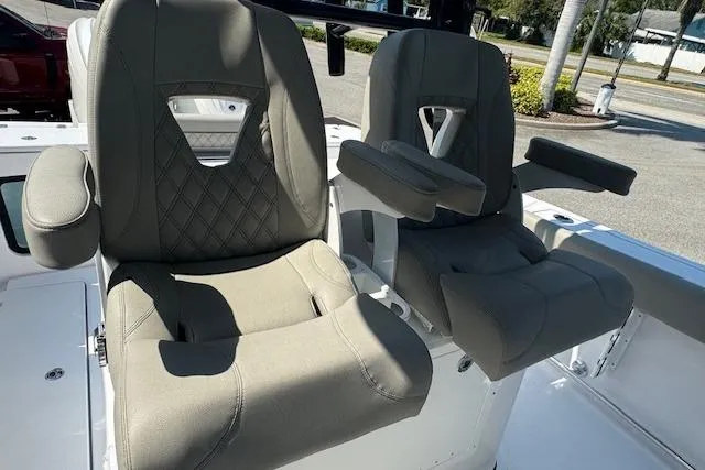 Slide: The Image of 2025 Sportsman Open 282 Center Console boat seats with armrests and diamond stitching. - 12