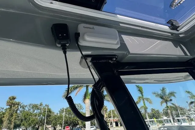 Slide: The Image of 2025 Sportsman Open 282 Center Console with Garmin equipment, palm trees in background. - 14