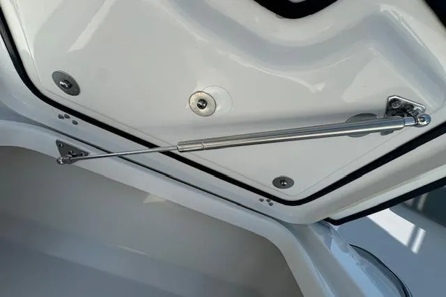 Slide: The Image of 2025 Sportsman Open 282 Center Console storage compartment with hydraulic lift support. - 16