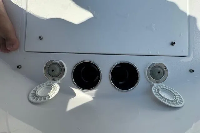 Slide: The Image of 2025 Sportsman Open 282 Center Console boat deck with open hatches and fittings. - 19