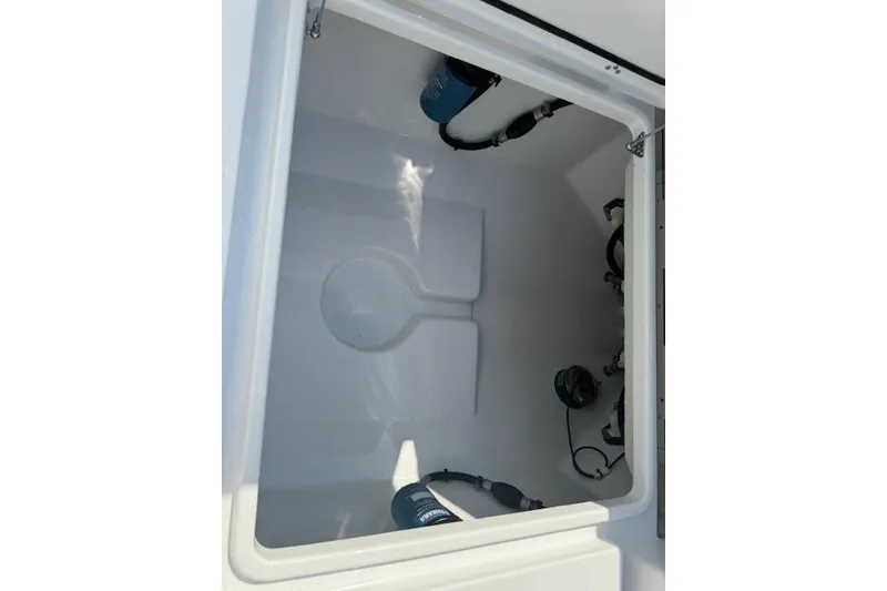 Slide: The Image of 2025 Sportsman Open 282 Center Console storage compartment with equipment. - 20