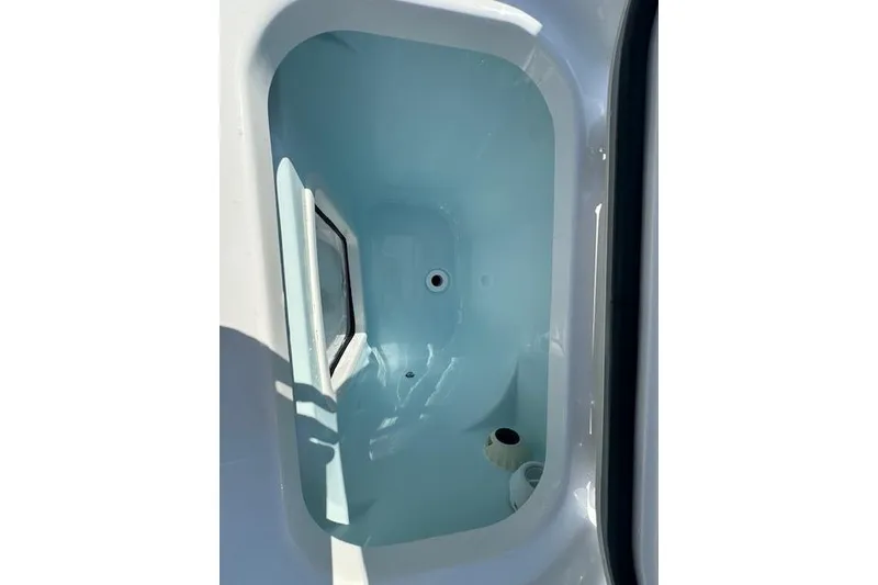 Slide: The Image of 2025 Sportsman Open 282 Center Console livewell interior, featuring a clean, white finish. - 24