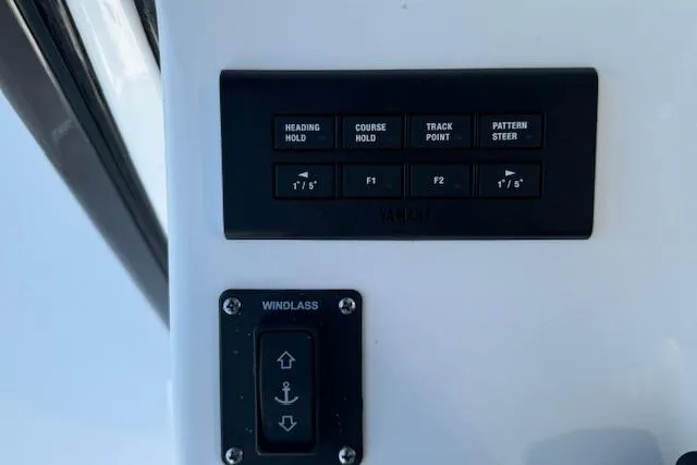 Slide: The Image of Control panel of 2025 Sportsman Open 282 Center Console boat with navigation and windlass buttons. - 31