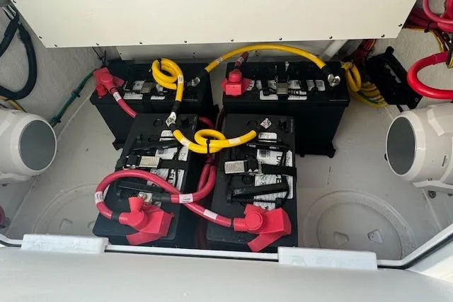 Slide: The Image of 2025 Sportsman Open 282 Center Console battery compartment with four batteries and wiring. - 34