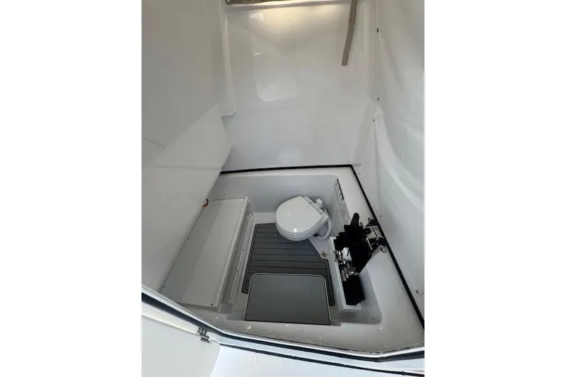 Slide: The Image of 2025 Sportsman Open 282 Center Console interior with marine toilet and storage. - 36